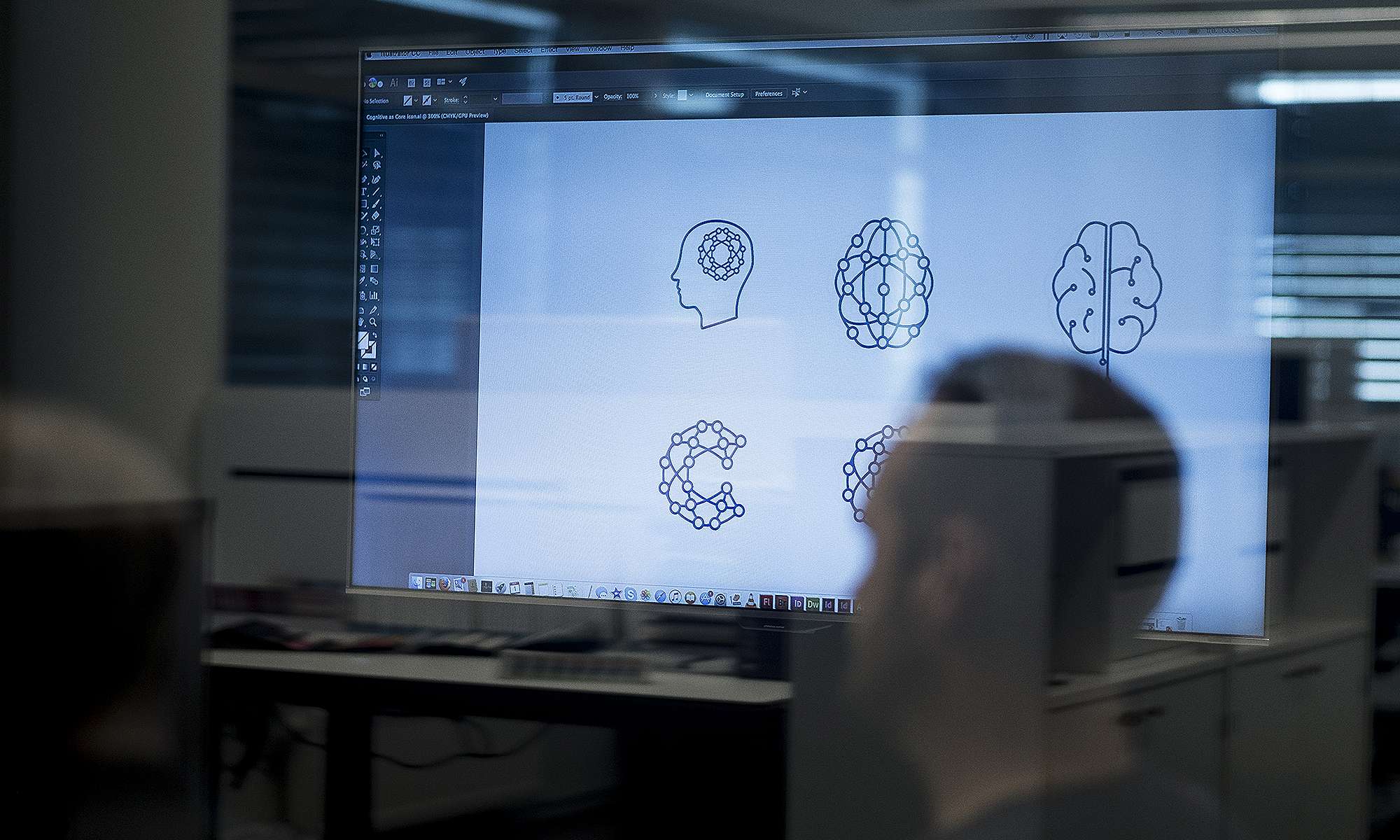 Bilde av designer på møterom foran skjerm med illustrasjoner